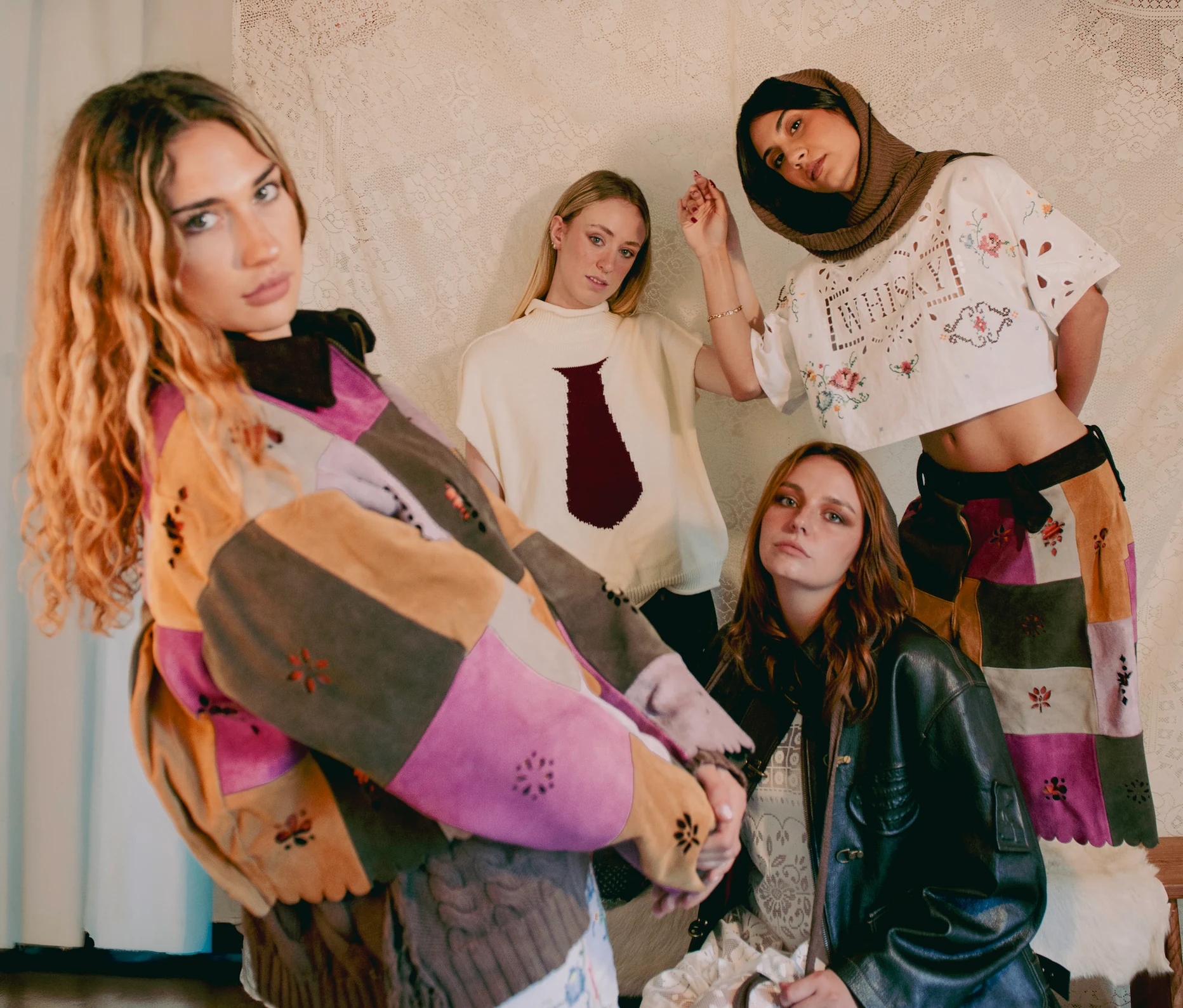 Four models wearing the Final Collection — suede patchwork, embroidered textiles, leather and knitwear