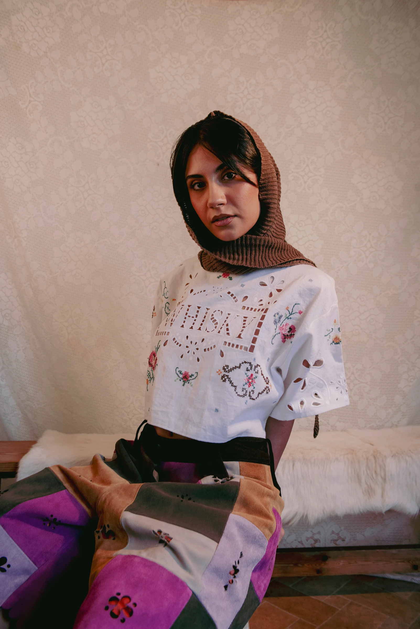 Look 3 — close portrait showing floral hand embroidery, cutwork and laser cut suede patchwork