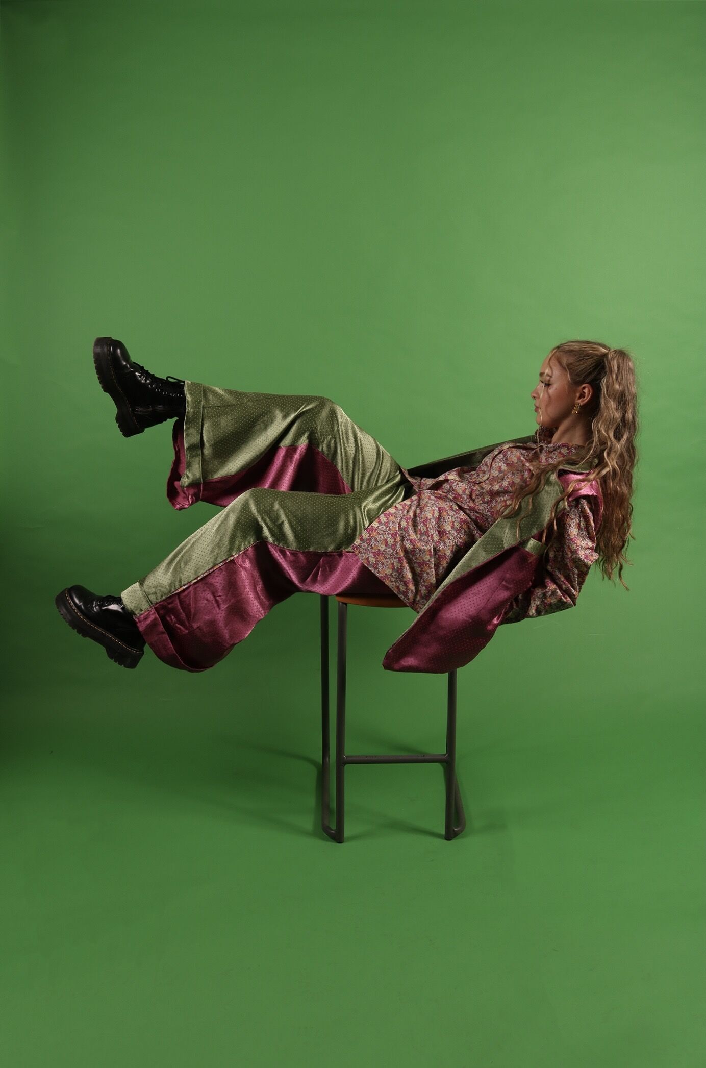 The Modern Dandy — final shoot, reclining pose against green backdrop